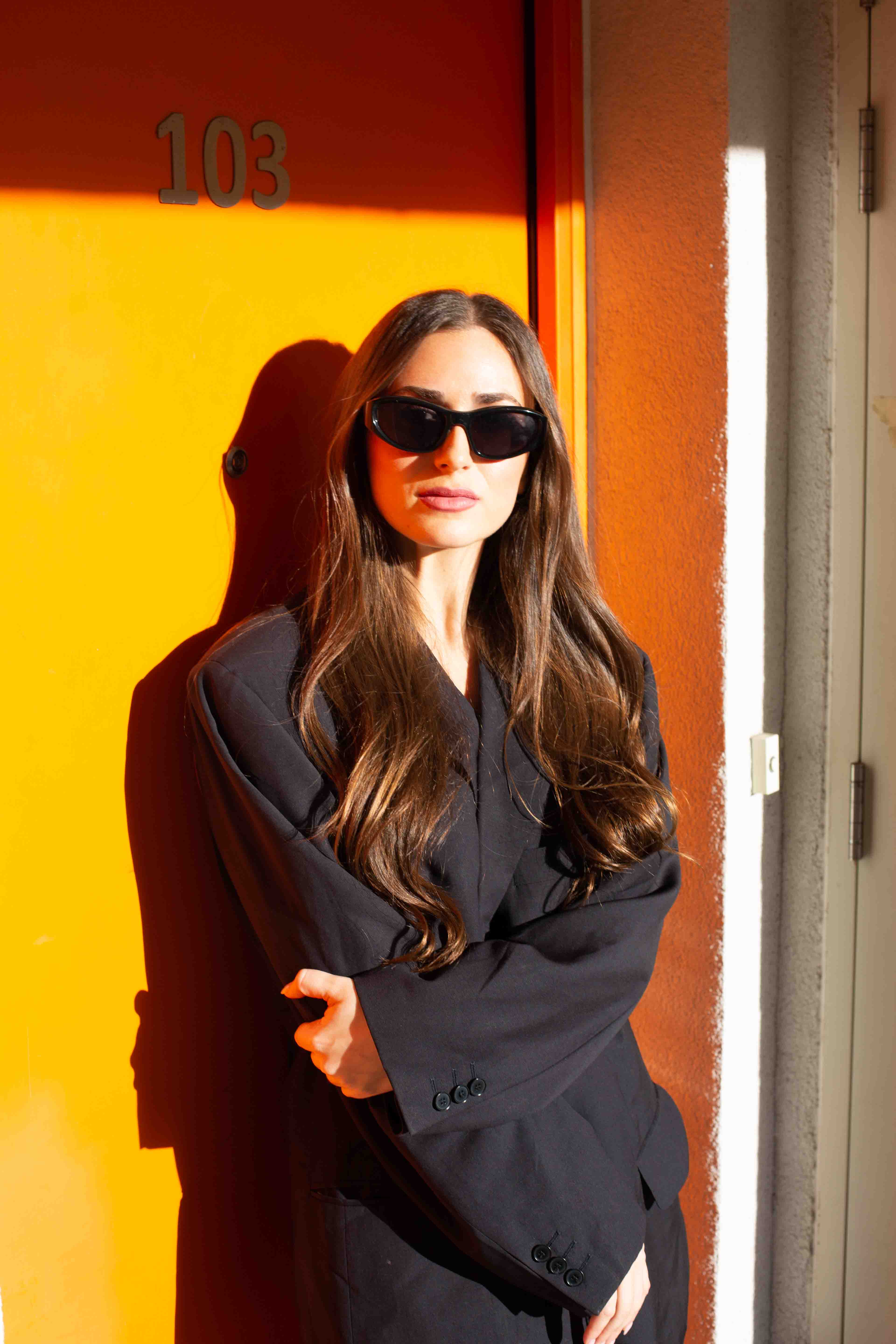 tilda arms crossed orange door