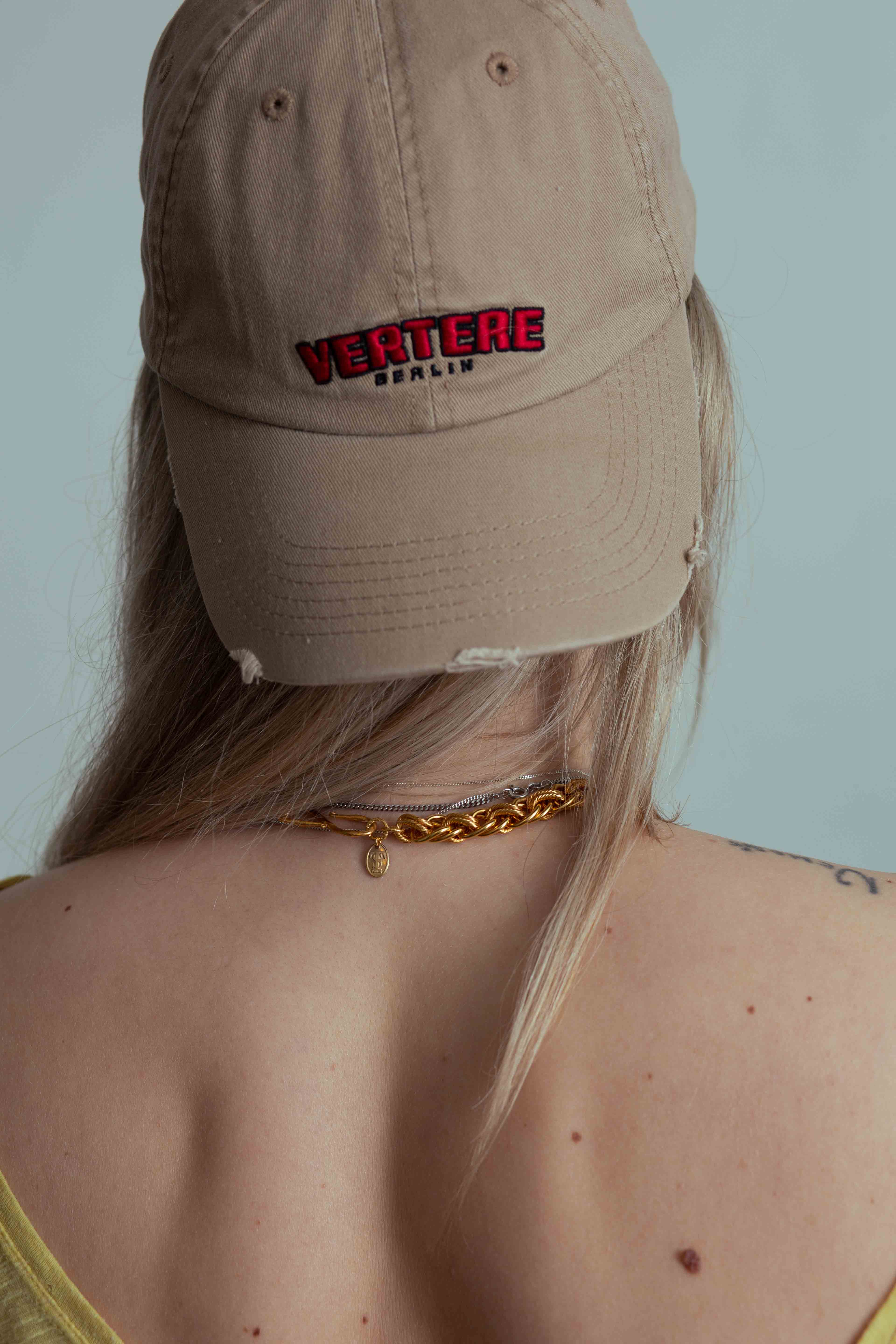 back of necklace and cap blonde hair