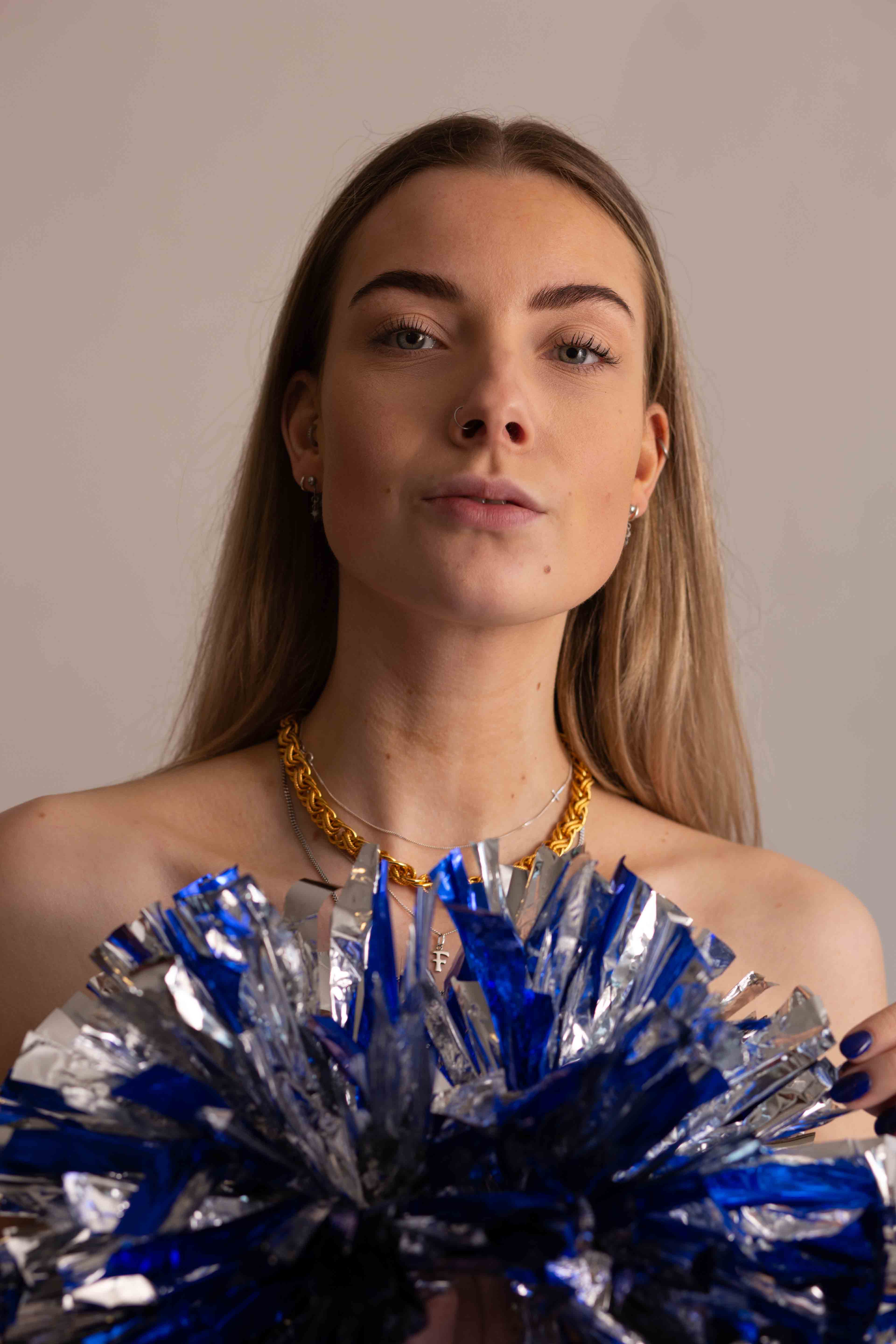 blonde portrait long hair wtih pom poms slight head tilt