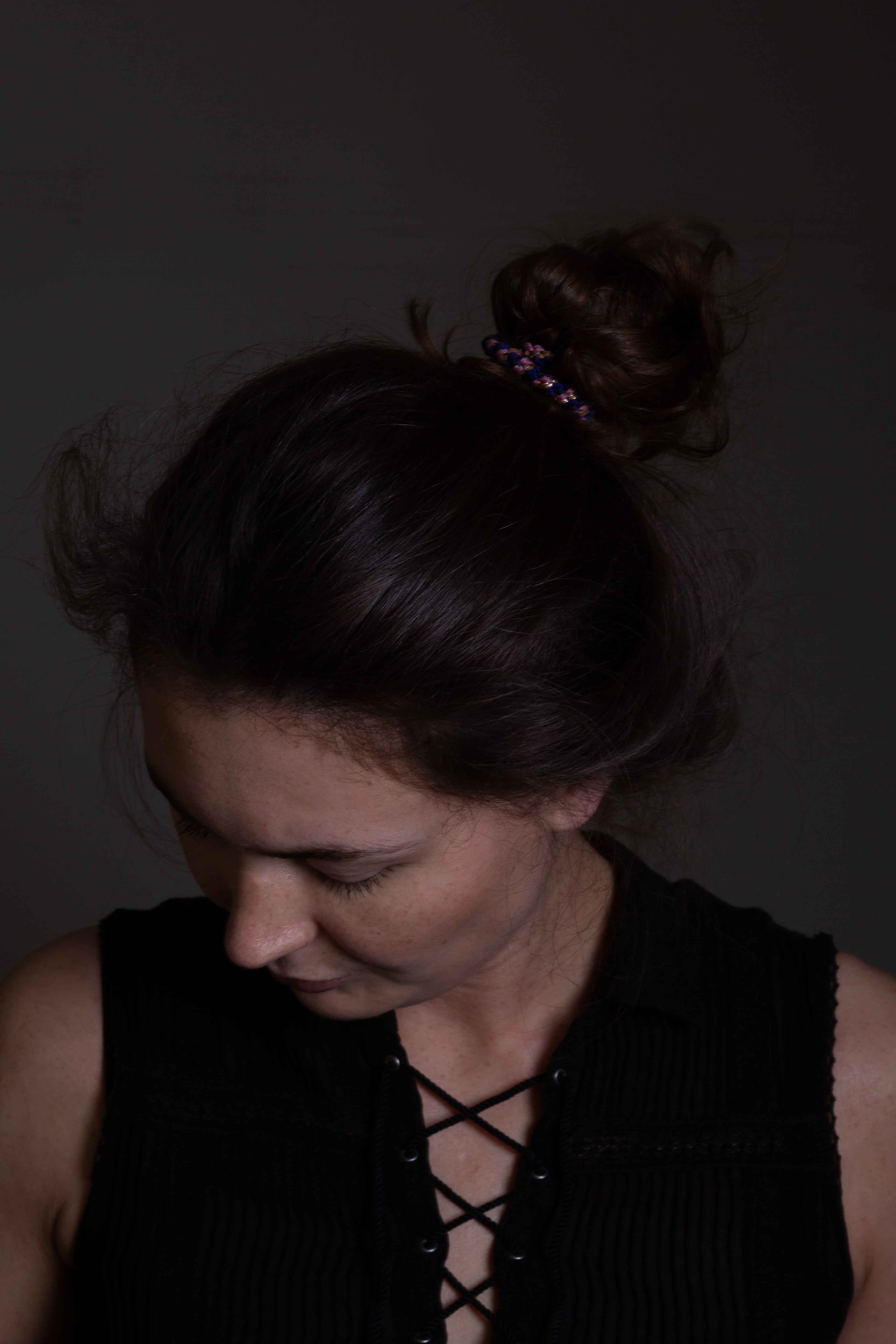 self portrait with bun looking down left