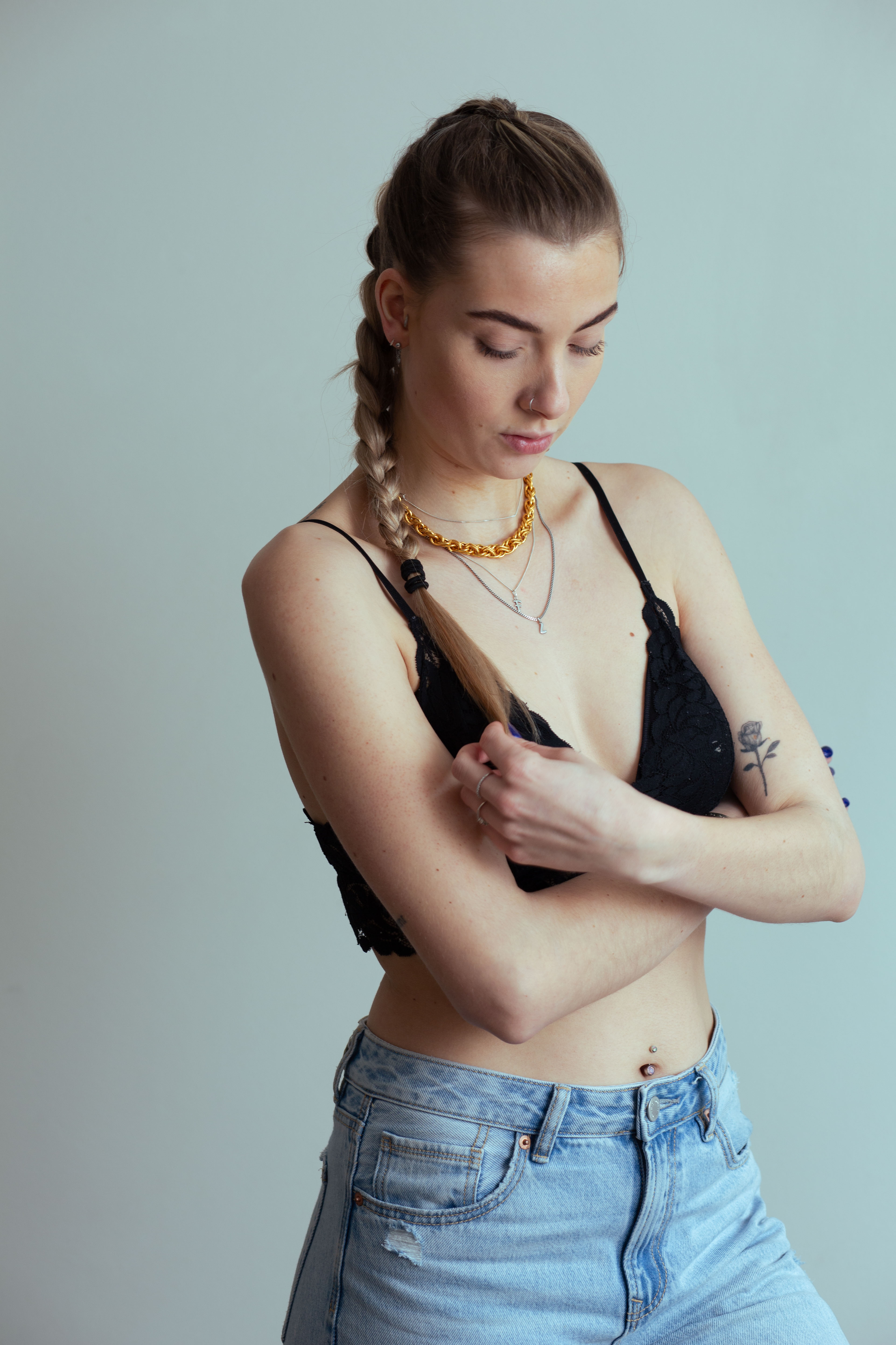 portrait of brunette model outside in chain necklace and white top